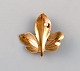 Scandinavian 
jeweler. 
Leaf-shaped 
brooch in 14 
carat gold 
adorned with 
cultured pearl. 
Mid-20th ...