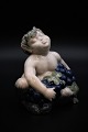 Royal 
Copenhagen 
porcelain 
figure of small 
pan figure with 
the arms full 
of blue grapes. 
Height: ...
