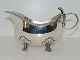 Silver gravy 
boat in heavy 
quality with 
flower handle 
and on four 
feet.
Hallmarked 
"830" and ...
