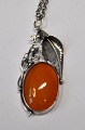 Silver pendant 
with polished 
amber, 20th 
century 
Denmark. With 
leaf 
decoration. 
Unstamped. ...