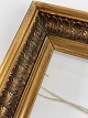 Old wooden gold 
frame with 
leaves and 
glass. The 
frame is from 
the beginning 
of the 20th ...