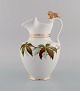 Antique Bing & 
Grøndahl 
chocolate jug 
in porcelain 
modeled with a 
lion on the 
handle. ...