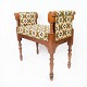 Piano bench of 
walnut and 
upholstered 
with patterned 
fabric, from 
the 1910s. The 
bench is in ...
