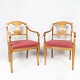 A pair of 
Empire 
armchairs of 
birch wood and 
upholstered 
with velvet, 
from around the 
1840s. The ...