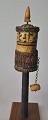 Nepalese prayer 
mill, 19th 
century. Of 
wood, bone and 
red coral. 
Inside with 
prayer paper 
rolled ...