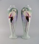 A pair of large 
large faience 
vases with 
hand-painted 
flamingos and 
lake pavilion. 
...