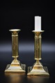 A pair of antique brass candlesticks, Height: 16cm. The candlesticks have an old engraving on ...