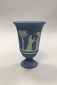 Wedgewood Blue 
Jasperware 
Arcadian Vase 
Decorated with 
the Sacrifice 
Bowl and Cupid. 
Measures 19 ...