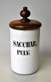 Pharmacies jar 
in white 
porcelain, 19th 
century 
Denmark. With 
mahogany lid. 
With the text: 
...