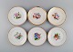 Six antique 
Bing & Grøndahl 
plates in 
porcelain with 
hand-painted 
flowers and a 
gold edge. Late 
...