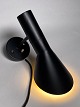 Arne Jacobsen wall lamp, black lacquered with switch in brass. Number 33080. Made by Louis ...