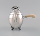 Georg Jensen 
Blossom 
chocolate pot 
in hammered 
sterling silver 
with handle of 
ivory. Model 
2A. ...
