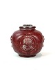 Stoneware 
lidded vase 
with ox blood 
coloured glaze 
and decorated 
with relief 
signed Jais 
Nielsen ...