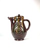 Ceramic jug 
with brown 
glaze decorated 
with pattern in 
the style of 
Art Nouveau 
from around the 
...