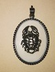 Pendant in 
silver with 
figure of crab 
on plate of 
bone. In good 
condition 
without damage 
or ...