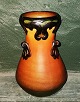 Pottery vase 
from P. Ipsen, 
Copenhagen. 
Orange with 
black 
decoration in 
relief. Made 
around ...