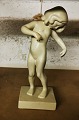 igure in 
ceramic of 
standing girl. 
Venus 
Kalypogos. 
Covered with 
cream-colored 
glaze. Made by 
...