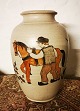 Ceramic vase 
from the Kähler 
factory. 
Decorated with 
young man and 
workhorse. The 
vase appears 
...