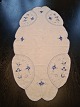 Table runs embroidered with blue fluted pattern Measures 46 x 91 cm. Appears with ...