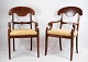A set of mahogany armchairs with light fabric from around the year 1860. Stands in fine ...
