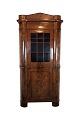 Antique north German corner cabinet in late empire in polished mahogany from around 1840s. The ...