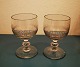 Pair of antique 
wine glasses. 
Decorated with 
vertical 
sanding on the 
basin. Button 
on the stem. 
...