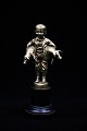 Old bronze figure of the pig boy holding 2 small pigs under the arm. The figure stands on a ...