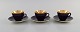 Three Royal 
Copenhagen / 
Aluminia 
Confetti mocha 
cups with 
saucers in 
purple glazed 
faience with 
...