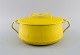 Jens H. 
Quistgaard 
(1919-2008), 
Denmark. Lidded 
pot in bright 
yellow enamel. 
1960s.
Measures: ...