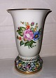 Trumpet shaped 
vase in 
porcelain with 
foot on which 
there are 
"flower beds" 
in relief. 
Painted ...