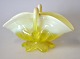 Pressed glass 
bowl in yellow 
colors with 
handle and 
foot, 20th 
century. Height 
.: 7.8 cm. L: 
13 cm.