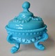 Bonbonniere in 
pressed glass, 
light blue, 
20th century. 
On three legs 
with dolphins. 
Lid in the ...