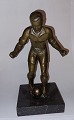 Figure of football player in bronze. Standing on stone base. Appears in good condition. ...