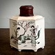 Chinese caddy 
of porcelain. 
Hexagonal body 
decorated with 
flowers, bird 
motifs in 
enamel colors 
...