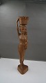 Large and beautiful teak wood figurine of young woman with basket on head, standing on 3-sided ...