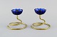 Gunnar Ander for Ystad Metall. Two candlesticks in brass and blue art glass shaped like flowers. ...