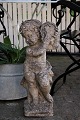 Old French sandstone figure with fine patina of little angel playing on tambourine. Height: 60cm.