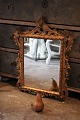 Antique French 1800 century wall mirror with carved gilded wooden frame with fine decorations ...