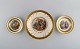 Three Royal 
Copenhagen 
bowls decorated 
with flowers 
and romantic 
scenery. Gold 
decoration. ...