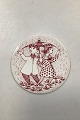Red monthly plate in faience for April "KONFLIKT" (conflict). Designed by Bjørn Wiinblad for ...