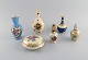 Limoges, 
France. Two 
perfume 
bottles, three 
vases and 
lidded box in 
hand-painted 
porcelain. ...