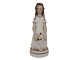 Royal 
Copenhagen 
overglaze 
figurine.
Huguenot girl 
designed by 
artist Arno ...