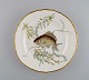 Royal 
Copenhagen 
porcelain lunch 
plate with 
hand-painted 
fish motif and 
golden border. 
Flora / ...