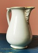 Jug in white 
porcelain with 
decoration of 
bisquit faces 
from Royal 
Copenhagen. 
Appears in good 
...