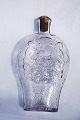 Clear glass 
pocket bottle. 
Decorated with 
various motifs 
in relief. Made 
around 1900. In 
good ...