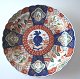 Imari plate, Japan, 19th century. Polycrom decoration. Dia.: 25 cm. With reparation. Rounded edge.