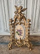 Large old picture frame decorated with an angel on top of the frameMeasure 21.5 x 35 cm.