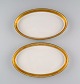Royal 
Copenhagen 
service no. 
607. Two oval 
porcelain 
dishes. Gold 
border with 
foliage. Model 
...