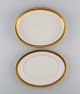 Royal 
Copenhagen 
service no. 
607. Two oval 
porcelain 
dishes. Gold 
border with 
foliage. ...