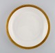 Royal 
Copenhagen 
service no. 
607. Round 
porcelain 
serving dish. 
Gold border 
with foliage. 
Model ...